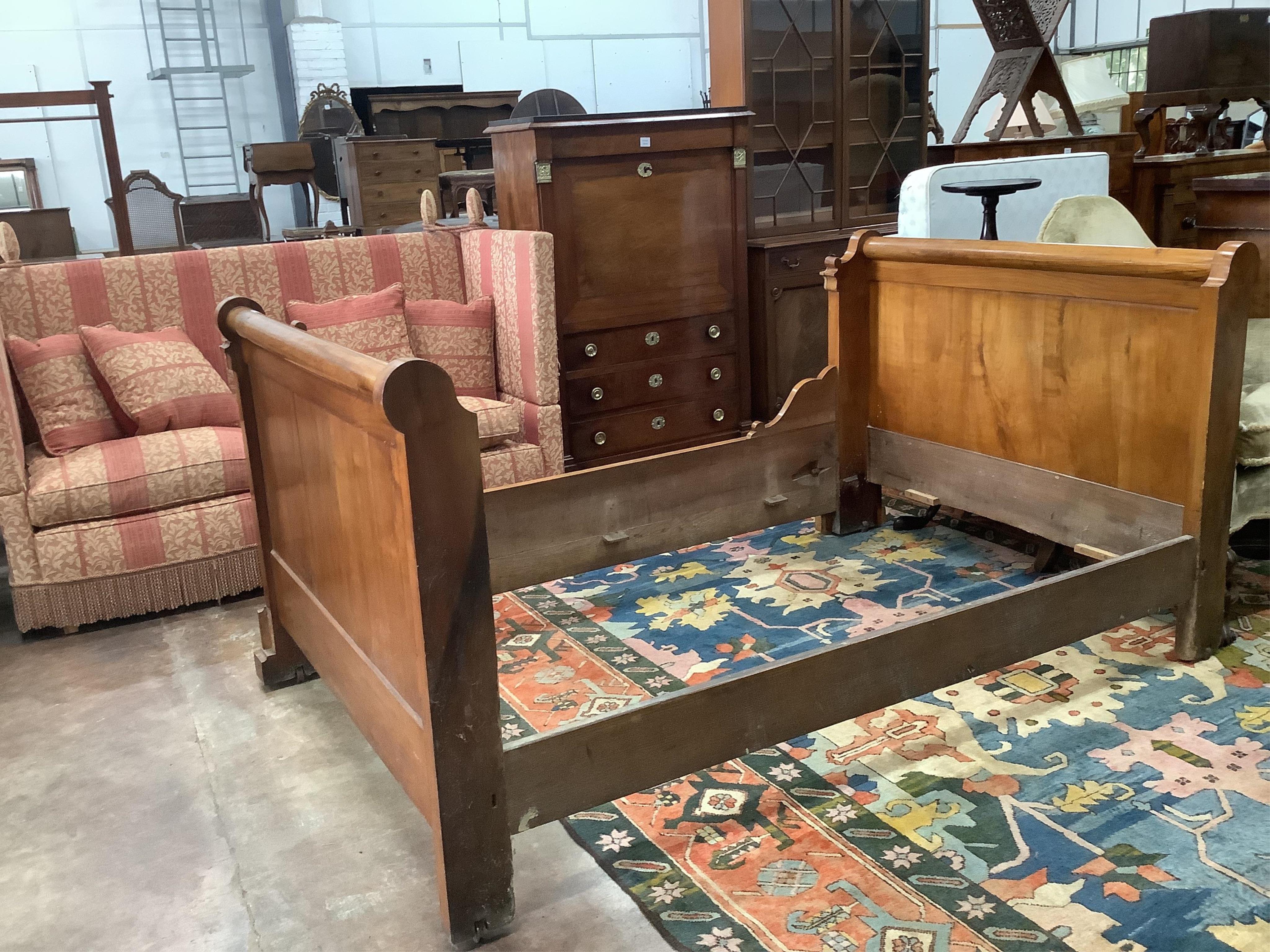 A 19th century French carved walnut sleigh bed, width 130cm, length 202cm, height 100cm. Condition - fair